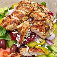 Greek salad with grilled chicken, feta, beets, olives, pepperoncini, cucumber and tomato